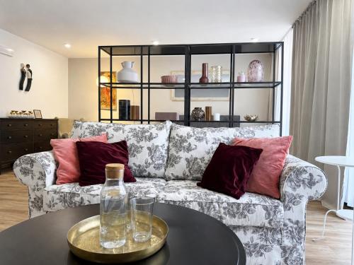 a living room with a couch and a table at Veleslaveenka - Spacious Apartment in Pilsen Old Town in Pilsen