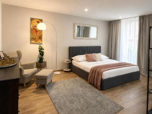 a bedroom with a bed and a living room at Veleslaveenka - Spacious Apartment in Pilsen Old Town in Pilsen