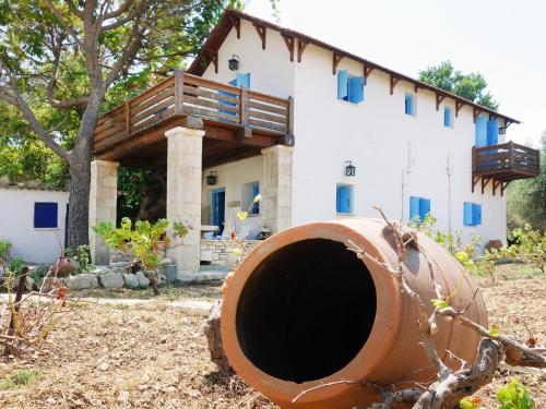 a house with a large pipe in front of it at Villa Antonia in Almyrida