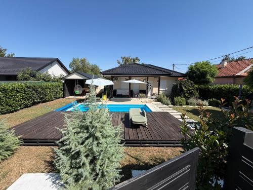 a backyard with a swimming pool and a house at MARINA HOUSE pool & garden in Beograd