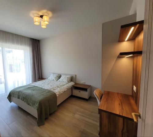 a bedroom with a bed and a window at Klaipedarent in Klaipėda