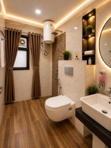 a bathroom with a white toilet and a sink at Hotel Aura Bellamonts Near Delhi Airport- Free Airport PickUp & Drop , Breakfast & Dinner Complementary in New Delhi