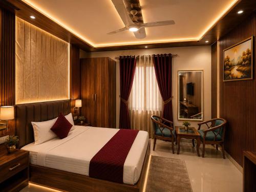a hotel room with a bed and a table at Hotel Aura Bellamonts Near Delhi Airport- Free Airport PickUp & Drop , Breakfast & Dinner Complementary in New Delhi