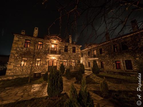 an old stone building with lights on it at night at Al Monte Hotel in Vronterón
