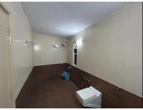 a bathroom with a toilet and a sink at Hotel shree darshan Dwarka in Dwarka