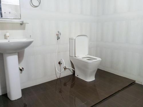 a bathroom with a white toilet and a sink at Ranweli Resort Anuradhapura in Anuradhapura