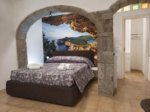 a bedroom with a bed with a painting on the wall at ALLOGGIO CASA IN PIETRA in Santu Lussurgiu