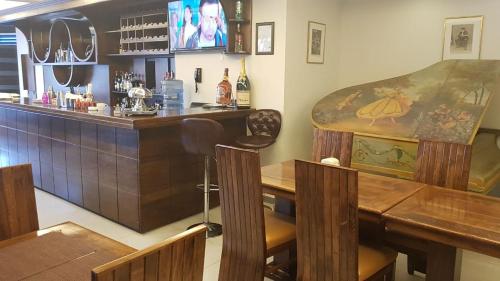 a bar with a counter and a table and chairs at hotel le noble in Beirut