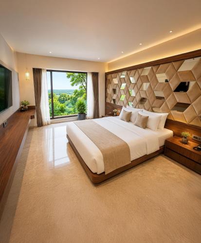 a bedroom with a large bed and a large window at Estrella The Resort in Karjat