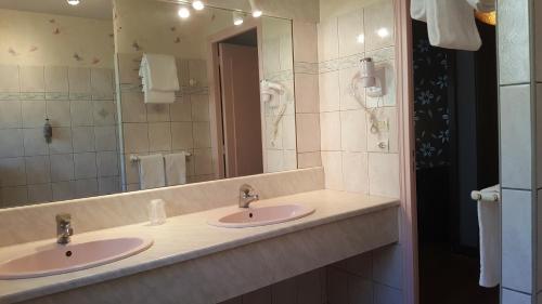 baño con 2 lavabos y espejo grande en Hotel Le Bon Laboureur, en La Charité-sur-Loire
