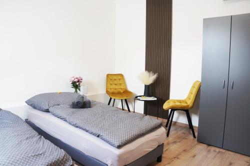 a bedroom with a bed and a table and chairs at Termál Vendégház in Leányfalu