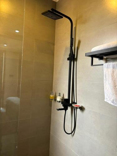 a shower in a bathroom with a glass shower at Armatyr Motel in Kampala