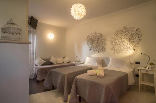 a hotel room with two beds and a chandelier at Geo House in Termoli