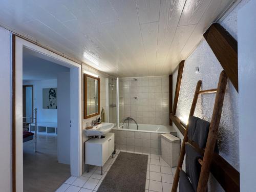 a bathroom with a tub and a sink at Ferienwohnung Silvia in Roßhaupten