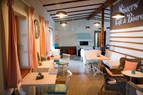 a restaurant with tables and chairs in a room at Camp Alpa in Ostrovačice