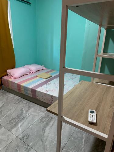 a bedroom with a bunk bed with a remote control at Ouzouri Wa Lijou in Mzouazia