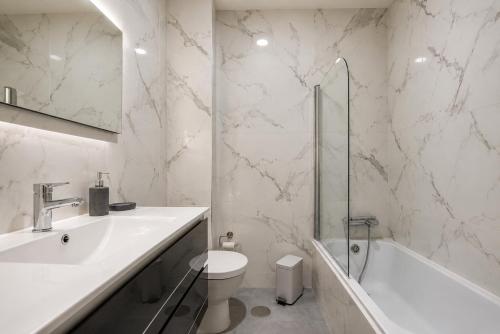 a bathroom with a sink and a toilet and a shower at Imperial apartment 1, 2 e 3 in Braga