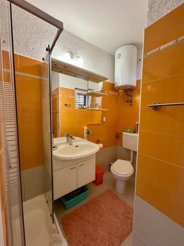 a bathroom with a sink and a toilet at Villa Saranda in Supetarska Draga