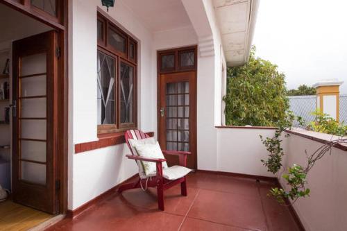a chair sitting on the porch of a house at Number5 Guesthouse in Cape Town