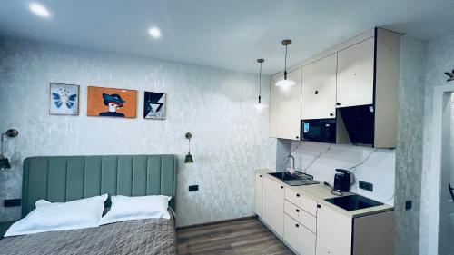 a small bedroom with a bed and a kitchen at ЖК Табигат in Borovoye