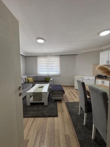 a living room with a couch and a table at Deluxe apartment Amar in Sarajevo