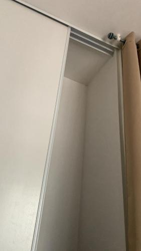a closet door with a metal pole on it at Antopom Heights & Suites in Sunyani