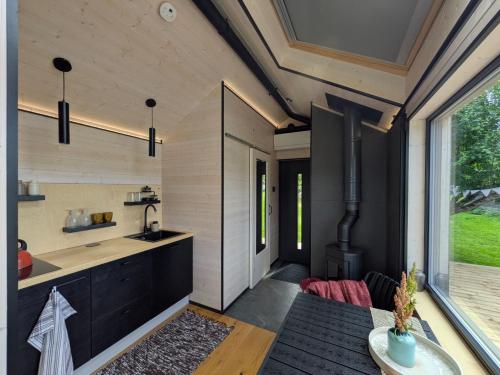 a kitchen and dining room of a house at Suur Muna Apple Garden Tiny Houses in Haanja