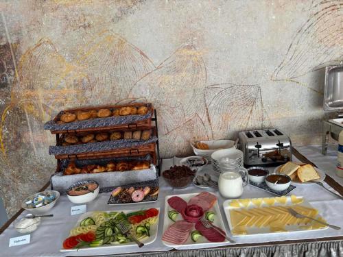 a table with many different types of food on it at Főnix Badacsony in Badacsonytomaj
