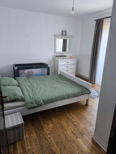 a bedroom with a bed and a dresser at Apartament cu 2 camere situat la etajul al doilea in Rădăuţi