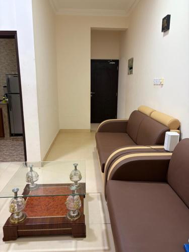a living room with a couch and a glass table at Sahnut in Salalah