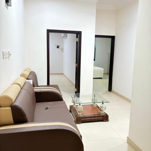 a living room with a couch and a glass table at Sahnut in Salalah