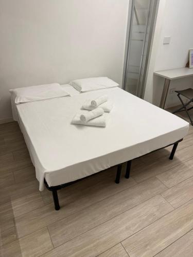 a white bed with two towels on top of it at Colombo 365 in Civitanova Marche