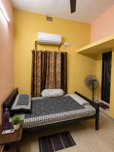 a bedroom with a bed in a room with a window at Jagdamba Bhawan in Kolkata