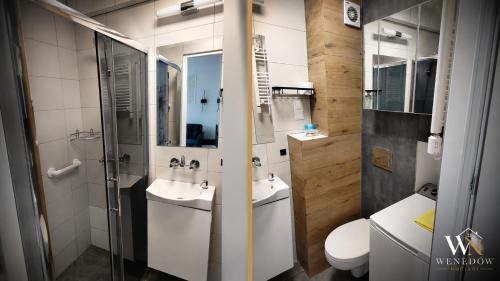 a bathroom with a shower and a sink and a toilet at 104 Wenedów Noclegi in Koszalin