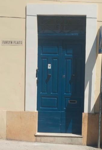 a blue door on the side of a building at 458 - Favlyn Boutique Apartments in Sliema