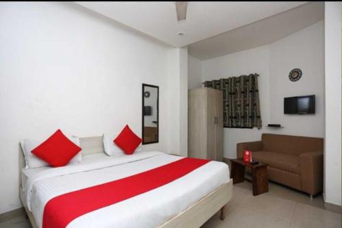 a bedroom with a large bed and a couch at Hotel Bir Stay- Near Nizamuddin Dargah in New Delhi