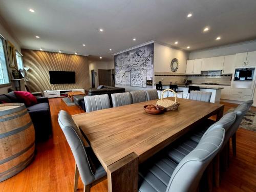 a kitchen and dining room with a wooden table and chairs at Westend House Healesville in Healesville