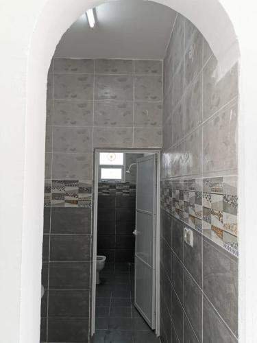 a bathroom with a shower and a toilet in it at شاليه شاطئ خلوف in Khalūf