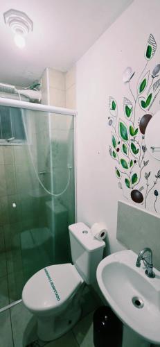 a bathroom with a shower and a toilet and a sink at Granja Vianna Charming in Cotia