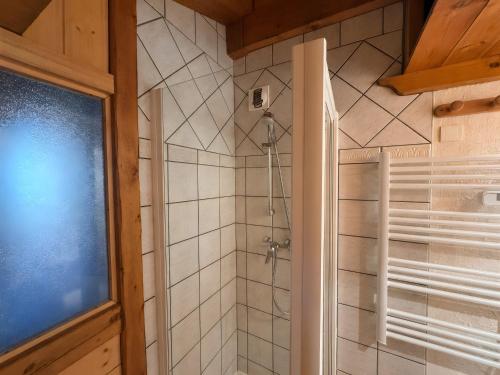 a bathroom with a shower with a glass door at Les Dolomites in La Plagne Tarentaise