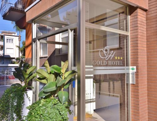 a store front with a sign in the window at Gold Hotel in Bordighera