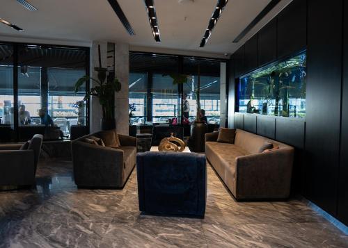 a lobby with couches and tables in a building at The V Hotel in Baghdād