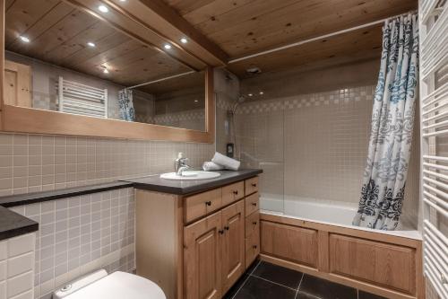 a bathroom with a toilet and a sink and a tub at Petit Bois - by Care Concierge in Demi-Quartier