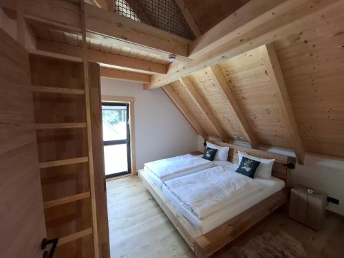 a small bedroom with a bed in the attic at Schwarzwald Wellness Chalet in Todtnau