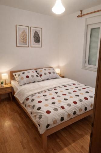 a bed in a bedroom with two pillows on it at Apartment Gonzales in Mostar