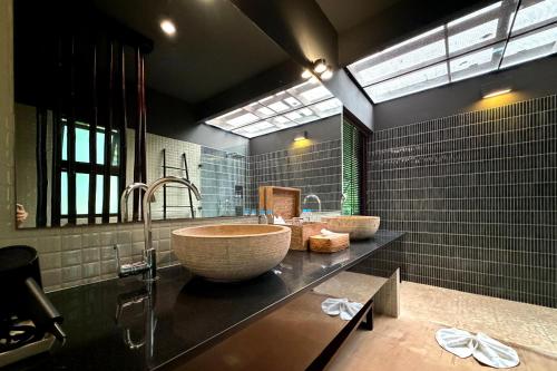 a bathroom with two sinks and a large bowl at Tha Lane Bay Villas in Tha Lane Bay