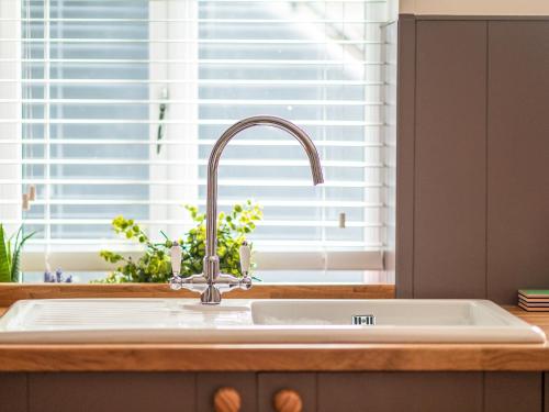 a kitchen sink in a kitchen with a window at Y Cwtsh in Llandeilo