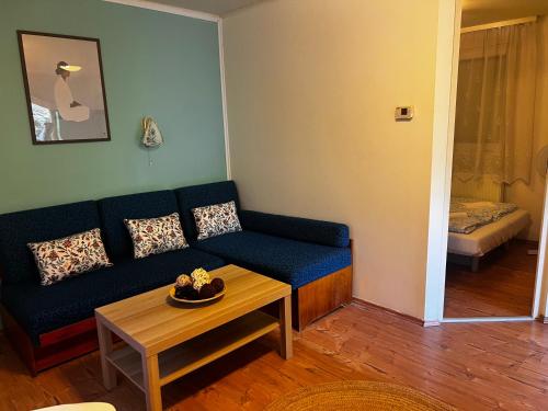 a living room with a couch and a table at AH-REMINI GARDEN Home in Siófok