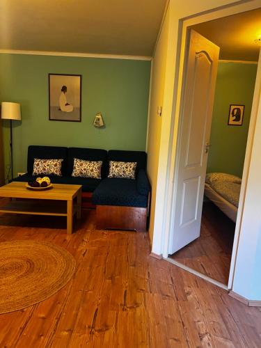 a living room with a couch and a table at AH-REMINI GARDEN Home in Siófok