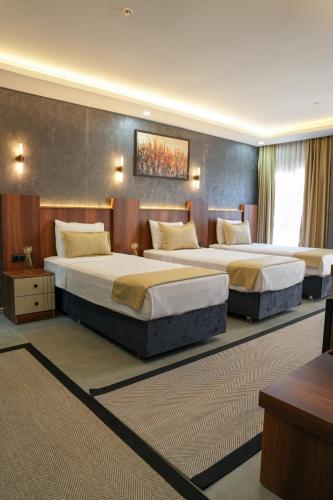 a hotel room with two beds in a room at Midyat Bay Grand Hotel in Midyat